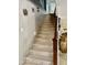 Carpeted staircase with dark wood railing leading to the upper level of the home at 21873 W Pima St, Buckeye, AZ 85326