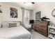 Clean bedroom with a comfortable bed, rocking chair, and large dresser at 2223 S Hughes Dr, Buckeye, AZ 85326