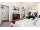Comfortable bedroom boasts a makeup vanity, black dresser and orange throw blanket at 2223 S Hughes Dr, Buckeye, AZ 85326