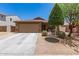 Charming single-story home featuring a two-car garage and desert landscaping at 2223 S Hughes Dr, Buckeye, AZ 85326
