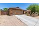 Charming single-story home featuring a two-car garage and desert landscaping at 2223 S Hughes Dr, Buckeye, AZ 85326