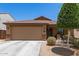 Charming single-story home featuring a two-car garage and desert landscaping at 2223 S Hughes Dr, Buckeye, AZ 85326