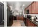 Well-lit kitchen featuring granite countertops, tile floors, and stainless steel appliances at 2223 S Hughes Dr, Buckeye, AZ 85326
