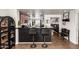 Modern kitchen with dark cabinetry, granite countertops, and bar seating at 2223 S Hughes Dr, Buckeye, AZ 85326