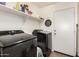 Functional laundry room with modern appliances and ample storage space at 2223 S Hughes Dr, Buckeye, AZ 85326