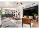 Open-concept living room with tile floors, modern furniture, and a large television at 2223 S Hughes Dr, Buckeye, AZ 85326