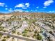 Expansive aerial view of a desert community nestled in front of a mountain range against a clear blue sky at 2315 W Duane Ln, Phoenix, AZ 85085