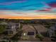 An aerial view showcases a home with desert landscaping in a community under a colorful sky at 2315 W Duane Ln, Phoenix, AZ 85085
