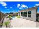 Paver patio and backyard featuring artificial turf, pool with water feature, and desert landscaping at 2315 W Duane Ln, Phoenix, AZ 85085