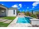 Inviting backyard with artificial turf, pool featuring a water feature, and desert landscaping and design at 2315 W Duane Ln, Phoenix, AZ 85085