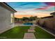 Beautiful backyard with artificial turf, paver walkway, and a serene pool at 2315 W Duane Ln, Phoenix, AZ 85085