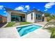 Beautiful backyard featuring a pool with water feature, lush green turf, and an inviting covered patio at 2315 W Duane Ln, Phoenix, AZ 85085
