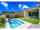 Gorgeous backyard features a pool, covered patio, artificial turf, and lovely desert landscaping at 2315 W Duane Ln, Phoenix, AZ 85085
