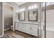 Bathroom features a double sink vanity with modern fixtures, a granite countertop, and wood-look floors at 2315 W Duane Ln, Phoenix, AZ 85085