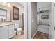 Well-lit bathroom featuring a wood-framed mirror, a toilet, and access to a bedroom with a ceiling fan at 2315 W Duane Ln, Phoenix, AZ 85085