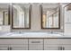 The bathroom features a double vanity with granite countertop, modern fixtures, and two framed mirrors at 2315 W Duane Ln, Phoenix, AZ 85085