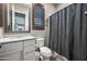 A secondary bathroom with a granite sink, a toilet, and a wooden shuttered window at 2315 W Duane Ln, Phoenix, AZ 85085