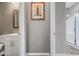 Neutral toned bathroom featuring a white vanity, framed mirror, and a framed London print above the base trim at 2315 W Duane Ln, Phoenix, AZ 85085