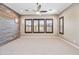 Spacious bedroom features a ceiling fan, carpeted floor, and three windows with shutter blinds at 2315 W Duane Ln, Phoenix, AZ 85085