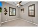 A spare bedroom with carpet flooring, a ceiling fan, and unique wall art at 2315 W Duane Ln, Phoenix, AZ 85085
