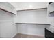 Walk-in closet featuring multiple shelves and a neutral carpet; great for organization and storage at 2315 W Duane Ln, Phoenix, AZ 85085