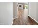 Bright hallway featuring wood floors leading to a light-filled living space at 2315 W Duane Ln, Phoenix, AZ 85085