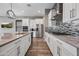 Modern kitchen featuring stainless steel appliances, a large island, and a stylish tile backsplash at 2315 W Duane Ln, Phoenix, AZ 85085