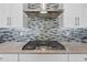 Modern stove top and tile backsplash in the kitchen at 2315 W Duane Ln, Phoenix, AZ 85085