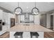 Gourmet kitchen features a large center island with bar seating and modern pendant lighting at 2315 W Duane Ln, Phoenix, AZ 85085