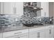 Close up of the stove and tile backsplash in the kitchen at 2315 W Duane Ln, Phoenix, AZ 85085