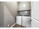 Functional laundry room with a white washer and dryer and a neutral color scheme at 2315 W Duane Ln, Phoenix, AZ 85085