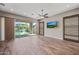 Spacious living room boasts wood floors, modern fan and sliding glass doors to backyard pool at 2315 W Duane Ln, Phoenix, AZ 85085