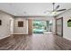 Open living room features wood-look tile floors and sliding glass doors to the backyard at 2315 W Duane Ln, Phoenix, AZ 85085