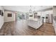 Spacious living area featuring wood floors, a kitchen island and sliding glass doors at 2315 W Duane Ln, Phoenix, AZ 85085