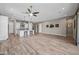 Open-concept living room flows into a spacious kitchen with a large center island and stylish pendant lighting at 2315 W Duane Ln, Phoenix, AZ 85085