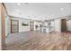 Bright, open-concept living area featuring wood floors, a kitchen island, and sliding glass doors at 2315 W Duane Ln, Phoenix, AZ 85085