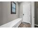 Mudroom featuring a storage bench, a window with shutters, and a white entry door at 2315 W Duane Ln, Phoenix, AZ 85085