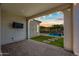 Covered patio with outdoor television, a view of the backyard, and a pristine pool at 2315 W Duane Ln, Phoenix, AZ 85085