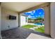 Covered patio with brick flooring, outdoor TV, and access to a backyard oasis with water feature at 2315 W Duane Ln, Phoenix, AZ 85085