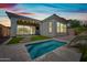 A backyard oasis featuring a sparkling pool, patio, and lush greenery under a vibrant sky at 2315 W Duane Ln, Phoenix, AZ 85085