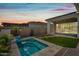 Inviting backyard pool with travertine tile surround, small palm trees, and covered patio with market lights at 2315 W Duane Ln, Phoenix, AZ 85085