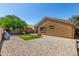 Expansive backyard offers ample space, a playhouse, basketball hoop, and low-maintenance gravel at 23749 W Grove St, Buckeye, AZ 85326