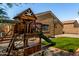 The backyard has a playhouse, basketball hoop, artificial turf, and gravel at 23749 W Grove St, Buckeye, AZ 85326