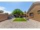 Backyard area featuring a playhouse, seating area, and low-maintenance gravel at 23749 W Grove St, Buckeye, AZ 85326