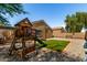Charming backyard with playhouse, basketball hoop, artificial turf, and rock ground cover at 23749 W Grove St, Buckeye, AZ 85326
