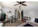 Bright bedroom with a ceiling fan, computer desk and shelving at 23749 W Grove St, Buckeye, AZ 85326