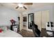 Well-lit bedroom with bed, computer desk, closet and ceiling fan at 23749 W Grove St, Buckeye, AZ 85326