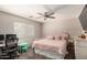 Comfortable bedroom featuring a ceiling fan, desk and a pink upholstered bed at 23749 W Grove St, Buckeye, AZ 85326