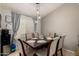 Inviting dining room features a dark wood table, seating for six, and modern pendant lighting at 23749 W Grove St, Buckeye, AZ 85326