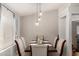 Cozy dining area with seating for six and modern lighting fixtures at 23749 W Grove St, Buckeye, AZ 85326